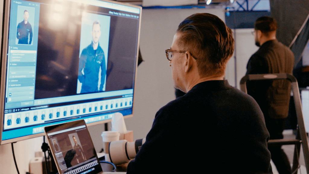 Man sitting at a computer screen editing a photo